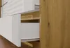 A close-up view of drawers in a piece of furniture, showing the white drawer fronts and the wood-grain side panel. Podgląd zdjęcia produktu