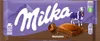 A Milka Noisette chocolate bar wrapper with a cow and mountains depicted. Produktbild-Vorschau