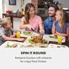A family is gathered around a dining table, with a roasted chicken as the centerpiece. A woman is in the process of carving the chicken, while a man and two children watch. Náhľad obrázku produktu