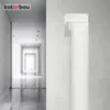 A white ventilation duct fitting is mounted on a textured wall, with a blurred hallway in the background. Produktbild-Vorschau