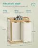A bamboo laundry basket with two compartments and a shelf, with dimensions and weight capacity indicated. Produktbild-Vorschau