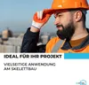 A construction worker wearing a hard hat and safety vest looks off into the distance, with a city skyline in the background. Produktbild-Vorschau