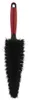 A cleaning brush with a red handle and black bristles, presented on a white background. Voir les images du produit
