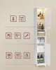 A tall, white bathroom cabinet with glass doors and internal lighting is shown. Icons representing bathroom accessories are arranged to the left of the cabinet. Produktbild-Vorschau