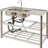 A stainless steel double sink with a faucet and drainboard, mounted on a metal frame with two shelves. Náhled obrázku produktu