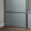 A close-up view of a light gray shoe cabinet with two doors, showing its ribbed texture and a hint of the surrounding room. Anteprima dell’immagine prodotto