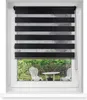A black and white striped roller blind is shown in a window, with a garden scene visible through the lower part of the window. Produktbild-Vorschau