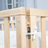 Close-up view of the wooden construction and fastening mechanism of a baby crib. Produktbild-Vorschau
