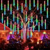 Outdoor Christmas decoration with string lights on a tree and house. Náhled obrázku produktu