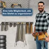 A man in a workshop setting is showcasing a boot organizer. Produktbild-Vorschau