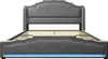 A grey upholstered bed frame with a headboard and footboard, shown from the front on a white background. The bed frame has a blue LED light strip along the bottom. Náhled obrázku produktu