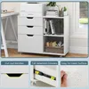 A white rolling storage cabinet with three drawers and an open shelf, placed next to a desk and near a window. The image is divided into sections, with the main product shot at the top and feature callouts at the bottom. Podgląd zdjęcia produktu