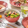A table setting with a fruit salad in a bowl, a glass of water with lemon and mint, and a soup bowl. Náhled obrázku produktu