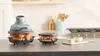 A kitchen counter with two food containers and a stove in the background. Anteprima dell’immagine prodotto