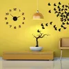 A wall clock with loose numbers and a decorative tree with butterflies on a yellow wall. Náhled obrázku produktu