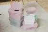 A collection of storage boxes stacked on a rug. Náhľad obrázku produktu