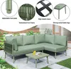 A green L-shaped garden lounge set with a coffee table is shown on a patio with grass and plants. Anteprima dell’immagine prodotto