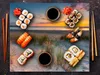 A flat lay of sushi and soy sauce on a beach-themed placemat. Náhľad obrázku produktu
