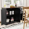 A black storage cabinet with two doors and two drawers, placed in a kitchen or dining area, with a coffee maker and fruit basket on top. Podgląd zdjęcia produktu