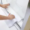 Hands cleaning a shower enclosure. Produktbild-Vorschau