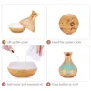 A four-panel collage showing the steps to set up and use an aroma diffuser. Produktbild-Vorschau