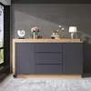 A modern sideboard with a wooden top and gray drawers, displayed in a room with a concrete wall and a window. Náhľad obrázku produktu