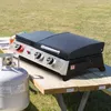 A propane tank and a Royal Gourmet tabletop gas grill are set up on a wooden picnic table outdoors. Produktbild-Vorschau