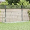 A metal chicken coop is set up on a grassy lawn in front of a wooden fence and a decorative lattice fence. Voir les images du produit
