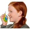 A young girl with red hair is holding a toy radio to her ear and speaking into it. Voir les images du produit