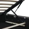 Close-up view of the internal mechanism of a bed frame, showing a gas lift mechanism and wooden slats. Produktbild-Vorschau
