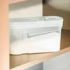 A clear plastic storage container filled with a white granular substance, placed on a shelf. Anteprima dell’immagine prodotto