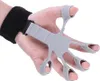 A hand wearing a finger exerciser and wrist strap against a white background. Náhled obrázku produktu