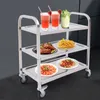 A three-tiered stainless steel kitchen trolley laden with food and drinks. Voir les images du produit