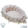 A baby nest with a braided bumper and a pillow, presented on a white background. Náhled obrázku produktu
