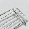 Close-up view of a metal drying rack with white plastic connectors. Produktbild-Vorschau
