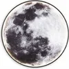 A close-up, detailed view of a round wall light designed to resemble the moon. Náhled obrázku produktu