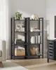 A modern living room with a black metal bookshelf filled with decorative items and books. Produktbild-Vorschau