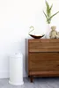 A diaper pail and a wooden dresser are shown in a room. Náhľad obrázku produktu