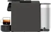 A side view of a black Nespresso coffee machine with a cup of coffee and a water tank. Produktbild-Vorschau