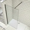 A modern shower enclosure with a black frame and glass panels, installed in a bathroom with white tiled walls and a white shower tray. Produktbild-Vorschau