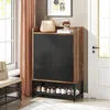A shoe cabinet with shoes on the bottom shelf, placed in an entryway next to a window and a door. Anteprima dell’immagine prodotto