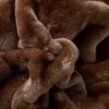 A close-up view of a brown, plush, textured fabric, likely a blanket or throw, with folds and creases creating depth and visual interest. Podgląd zdjęcia produktu