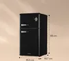 A black retro-style refrigerator with dimensions indicated by dashed lines and measurements. Produktbild-Vorschau
