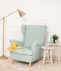 A light blue armchair with a yellow octopus plush toy on its seat, next to a small white side table with a vase and a clock. Anteprima dell’immagine prodotto