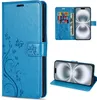 A collage of images showing a blue flip phone case with a floral and butterfly design, including a view of the case open with cards and money inserted, and a view of the phone in the case standing up. Produktbild-Vorschau