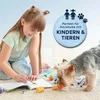 A young girl is painting on the floor next to a dog, surrounded by art supplies. Voir les images du produit