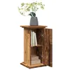 A wooden cabinet with an open door, displaying books and boxes inside, topped with a vase of flowers. Voir les images du produit