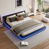 A modern bedroom with a black upholstered bed frame featuring blue LED lighting, a white nightstand, and a large window. Anteprima dell’immagine prodotto