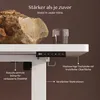 A close-up view of a white desk with a control panel, a glass of water, and a rock on top, highlighting its stability and features. Anteprima dell’immagine prodotto
