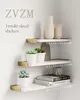 Three white corner shelves with gold brackets are mounted on a white wall, decorated with plants, vases, and books. Produktbild-Vorschau